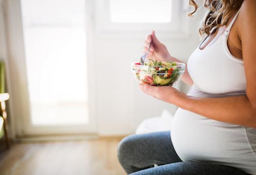 pregnant woman eating healthy salad